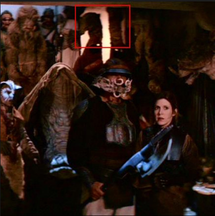 The two-headed Cane Adiss (in the red square in the background) is briefly visible in this "Return of the Jedi" scene in Jabba's palace.